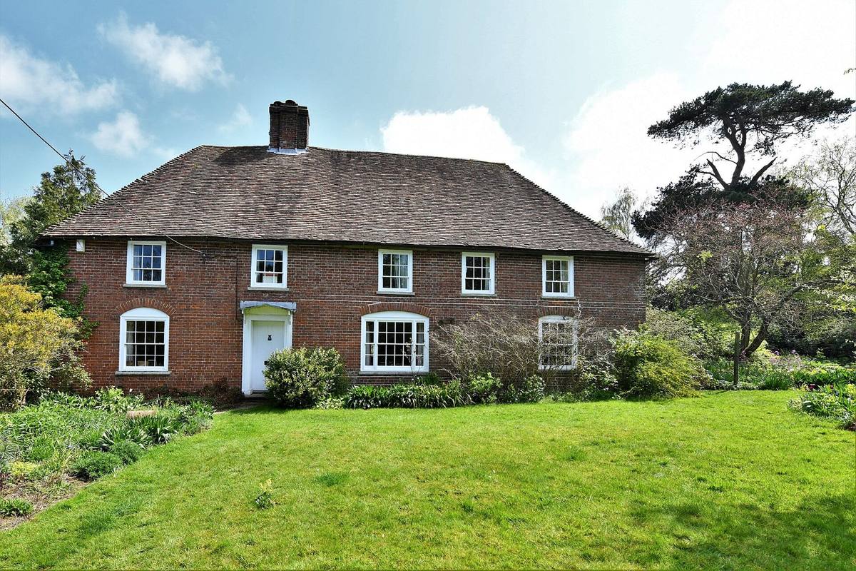 A red-brick Georgian farmhouse with a sweeping lawn in the Kent countryside near Eastling