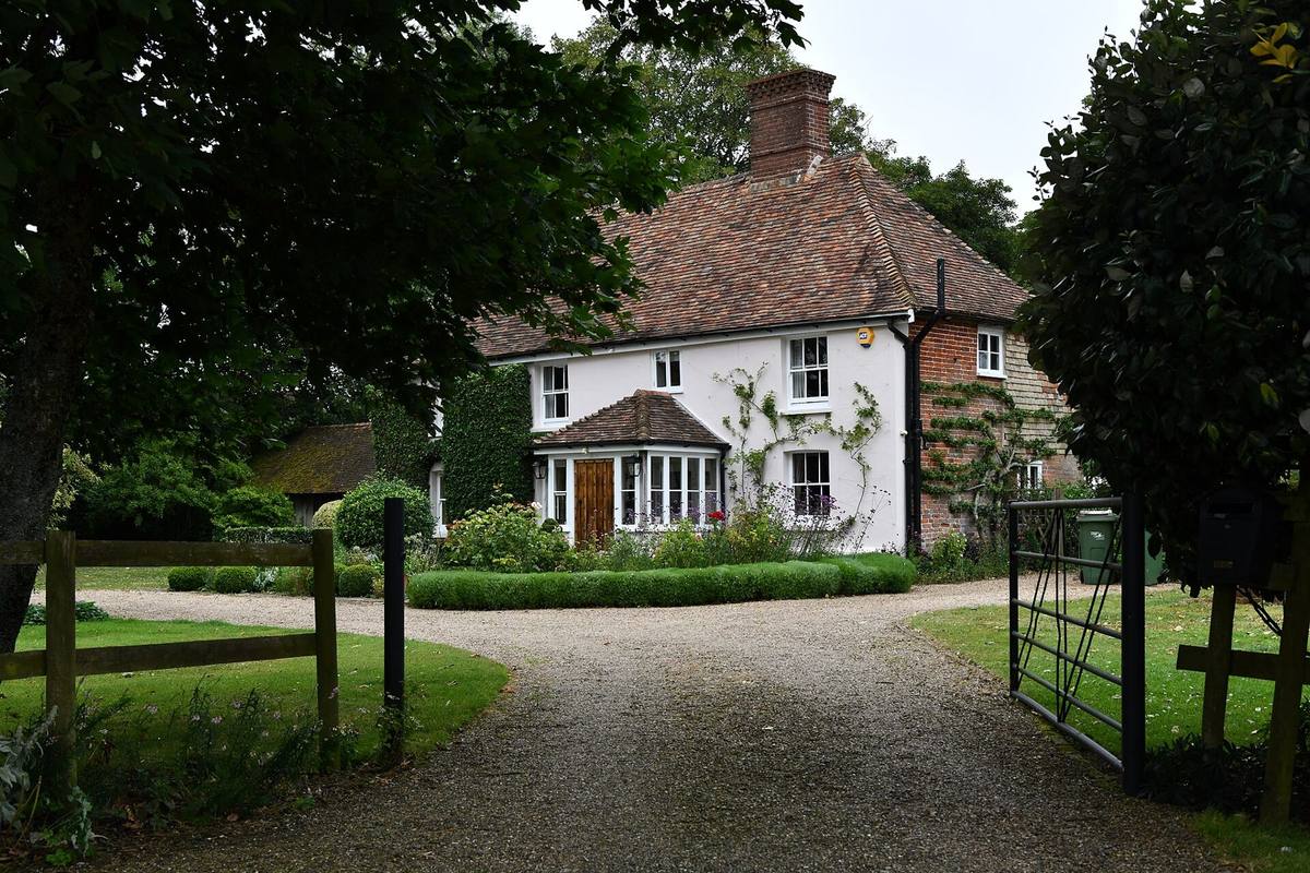 A tile-hung farmhouse at the end of a gravel driveway at Stowting Common, Kent